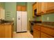 Eat-in kitchen featuring full-size refrigerator, gas range, and ample cabinet space at 415 N Fern Creek Ave, Orlando, FL 32803