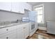 Well-lit kitchen featuring modern appliances and countertops, white cabinets, and wood-look vinyl floor at 415 N Fern Creek Ave, Orlando, FL 32803