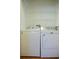 Laundry area features a white washer and dryer with wire racks above at 415 N Fern Creek Ave, Orlando, FL 32803