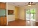 Bright, open living space with wood floors, ceiling fan, sliding door to balcony and pass through to kitchen at 415 N Fern Creek Ave, Orlando, FL 32803