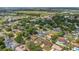 Expansive aerial view of a community with mature trees, showcasing the neighborhood layout and surroundings at 4636 Mesa Verde Dr, St Cloud, FL 34769