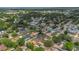 Panoramic aerial shot of a leafy neighborhood with a glimpse of the water in the distance at 4636 Mesa Verde Dr, St Cloud, FL 34769