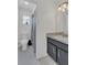 Cozy bathroom featuring a shower and tub combination, marble vanity, and warm, inviting lighting at 4636 Mesa Verde Dr, St Cloud, FL 34769