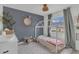 Charming bedroom featuring a unique bed frame, decorative mirror, and a peaceful, inviting atmosphere at 4636 Mesa Verde Dr, St Cloud, FL 34769