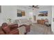 Comfortable living room with a ceiling fan, a large sofa, and stylish decor at 4636 Mesa Verde Dr, St Cloud, FL 34769