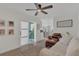 Bright living room with a view to a sunroom, comfortable seating, and modern decor at 4636 Mesa Verde Dr, St Cloud, FL 34769