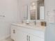 Bright bathroom featuring double sinks, sleek countertops, and modern fixtures at 485 Famagusta Dr, Davenport, FL 33896