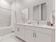 Modern bathroom with double vanity, marble countertops, and sleek fixtures at 485 Famagusta Dr, Davenport, FL 33896