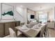 Elegant dining room with modern decor, stylish furnishings, and easy access to living room at 485 Famagusta Dr, Davenport, FL 33896