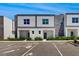 Modern townhome exterior with stone accents, manicured landscaping, and convenient parking at 485 Famagusta Dr, Davenport, FL 33896