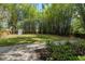 Serene backyard featuring a storage shed, mature trees, and manicured lawn, ideal for outdoor enjoyment at 506 S Hyer Ave, Orlando, FL 32801