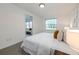 Cozy bedroom with natural light and a comforting view of the outdoor through a large window at 506 S Hyer Ave, Orlando, FL 32801