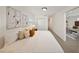 Comfortable bedroom with a view to the living room; features soft lighting and white bedding at 506 S Hyer Ave, Orlando, FL 32801