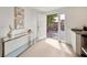 Bright foyer featuring tile floors, a glass console table, and a white front door at 506 S Hyer Ave, Orlando, FL 32801