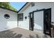 Home exterior showcases a white front door framed with black trim and a wooden porch at 506 S Hyer Ave, Orlando, FL 32801