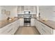 Well-designed kitchen showcasing sleek appliances, granite countertops, and white cabinets at 506 S Hyer Ave, Orlando, FL 32801