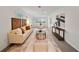 Bright living room featuring neutral furniture, decor, and a decorative rug with a glass coffee table at 506 S Hyer Ave, Orlando, FL 32801