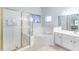 Bright bathroom featuring a glass enclosed shower and a soaking tub at 509 New Providence, Davenport, FL 33897