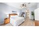 Bright bedroom with a wooden bed frame and tiled flooring, next to the bathroom at 509 New Providence, Davenport, FL 33897