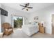 Bright bedroom featuring a ceiling fan, closet, and sliding door to a balcony at 509 New Providence, Davenport, FL 33897