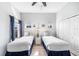 Bright bedroom with two twin beds, light gray walls, and seaside themed decorations at 509 New Providence, Davenport, FL 33897
