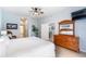 Bedroom featuring wood furnishings, a ceiling fan, tiled floors and an open doorway at 509 New Providence, Davenport, FL 33897