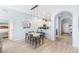 Open dining area with wood floors, modern pendant lighting, and views into the kitchen at 509 New Providence, Davenport, FL 33897