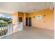Peach-colored condo hallway with two doors, a white railing, and a small window at 509 New Providence, Davenport, FL 33897