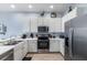 Bright kitchen featuring white cabinets, stainless steel appliances, and hardwood floors at 509 New Providence, Davenport, FL 33897