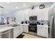 Well-equipped kitchen featuring stainless steel appliances and ample countertop space at 509 New Providence, Davenport, FL 33897
