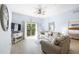 Bright living room showcases furniture, tv, sliding door to a balcony at 509 New Providence, Davenport, FL 33897