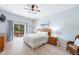 Comfortable main bedroom with a private balcony and light wood floors at 509 New Providence, Davenport, FL 33897