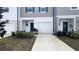 Charming townhome with a one-car garage, well-manicured landscaping, and a private driveway at 516 Madison Dr, Davenport, FL 33837