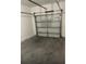 Clean, empty single-car garage featuring a concrete floor, and an automatic door opener at 516 Madison Dr, Davenport, FL 33837