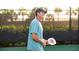 Personal holding a pickleball paddle on the pickleball court at 5333 Spoonflower Ct, St Cloud, FL 34771