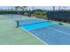 Outdoor pickleball courts featuring vibrant blue and green surfaces, nets, and fencing at 5333 Spoonflower Ct, St Cloud, FL 34771