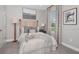 Comfortable bedroom features a plush bed, modern décor, and soft natural light from the window at 5337 Spoonflower Ct, St Cloud, FL 34771