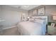 Serene bedroom features soft gray walls, plush carpet, decorative artwork, and a king-sized bed at 5337 Spoonflower Ct, St Cloud, FL 34771
