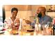 Adults enjoying a happy hour at a dinner table filled with bottles and glasses of wine at 5337 Spoonflower Ct, St Cloud, FL 34771