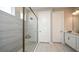 Bathroom featuring a glass shower, white cabinets, and modern tile design at 549 Moon Shell Cir, New Smyrna Beach, FL 32168