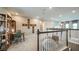 Upstairs loft area featuring study space, railing, and accent furniture at 549 Moon Shell Cir, New Smyrna Beach, FL 32168