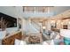 Cozy living room showcasing modern decor, staircase, and an open layout connected to the kitchen at 549 Moon Shell Cir, New Smyrna Beach, FL 32168