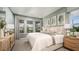 Comfortable main bedroom with three windows, art, and light-colored walls at 549 Moon Shell Cir, New Smyrna Beach, FL 32168