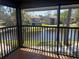Serene balcony view overlooking a peaceful pond surrounded by well-maintained lawns and trees at 5926 Peregrine Ave # A13, Orlando, FL 32819