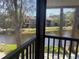 Scenic balcony view overlooking a tranquil pond surrounded by lush greenery and nearby condos at 5926 Peregrine Ave # A13, Orlando, FL 32819