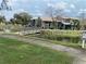 Scenic community featuring charming condominium buildings near a serene pond with a walkway at 5926 Peregrine Ave # A13, Orlando, FL 32819