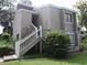 Two-story exterior view featuring a wooden staircase leading to the entrance at 5926 Peregrine Ave # A13, Orlando, FL 32819
