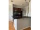 Open kitchen with stainless steel appliances and breakfast bar at 5926 Peregrine Ave # A13, Orlando, FL 32819