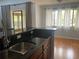 Open kitchen overlooking the dining area, with granite countertops and laminate floors at 5926 Peregrine Ave # A13, Orlando, FL 32819