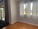 Bright living space featuring hardwood floors, natural light, and sliding glass doors to balcony at 5926 Peregrine Ave # A13, Orlando, FL 32819